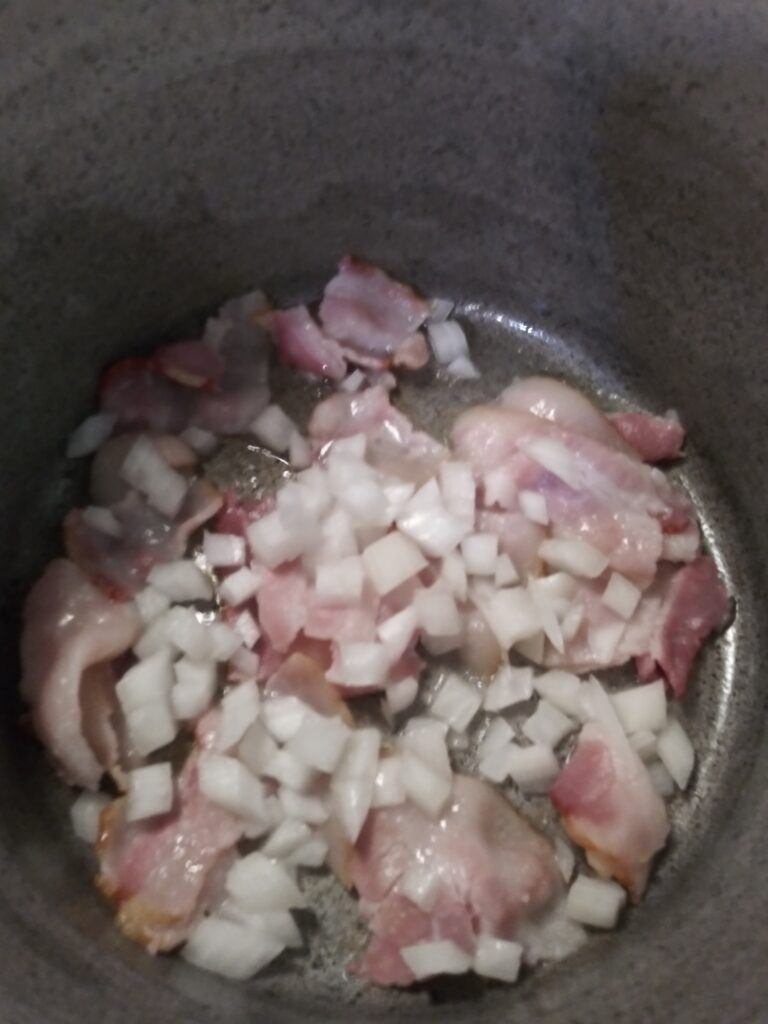 Frying bacon and onion in a pan