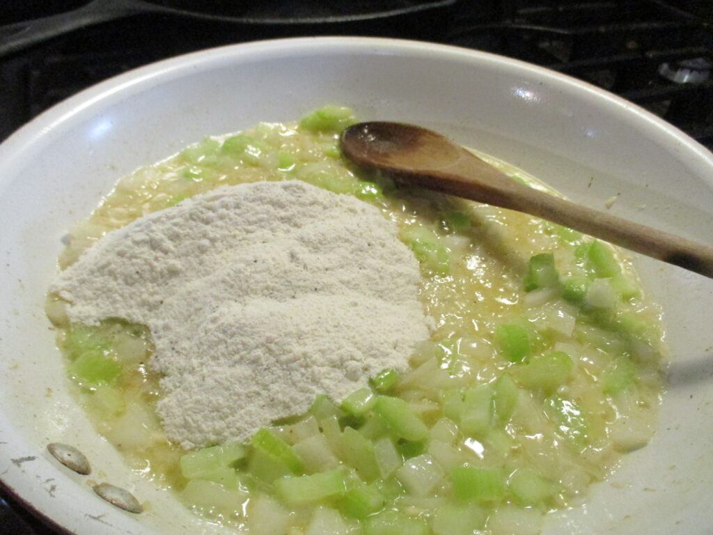 Mixing celery and onions with flour